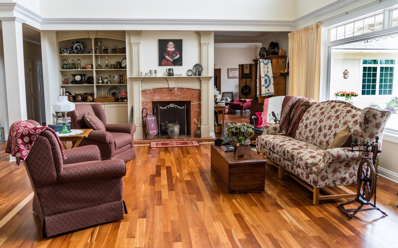 Charming living room featuring classic decor, patterned upholstery, and a cozy fireplace setting.