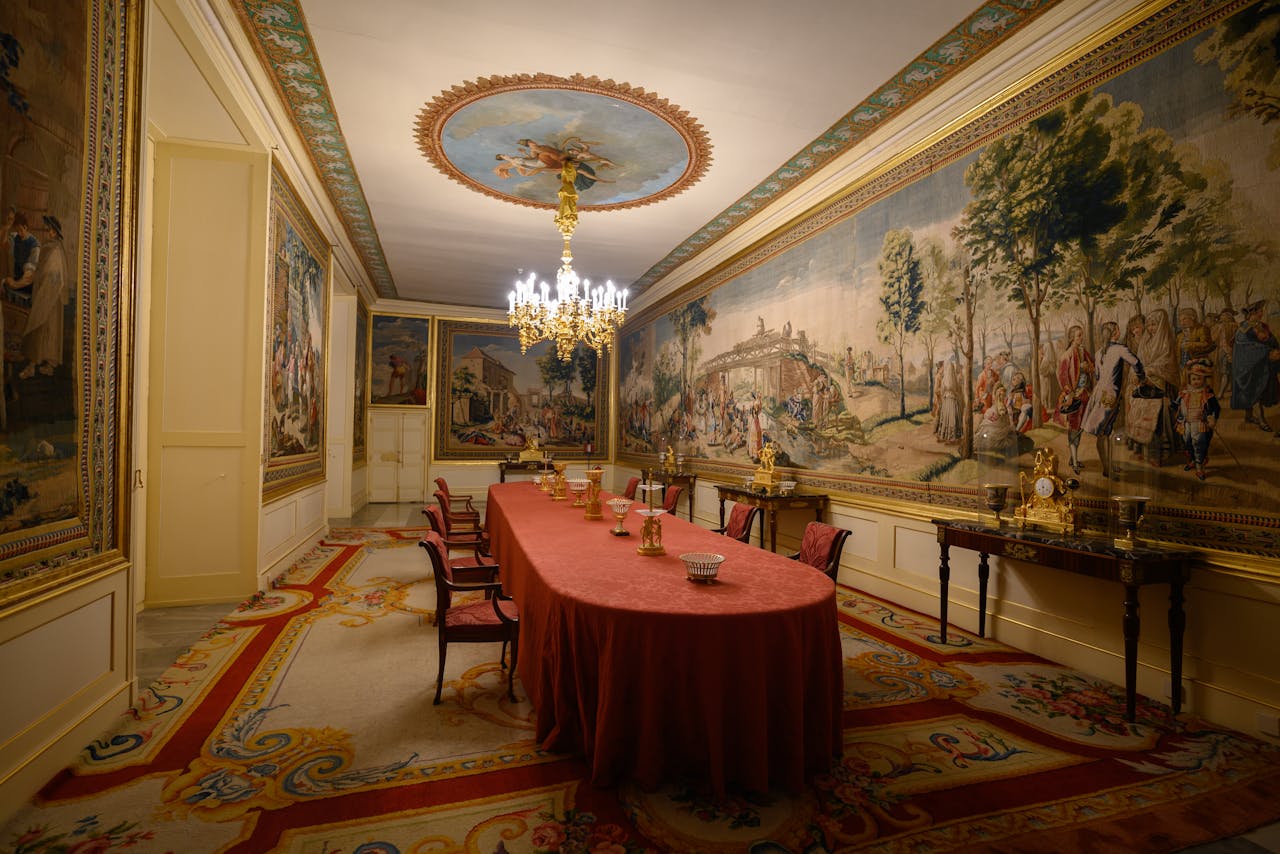 Richly decorated dining room with tapestries and chandelier in Madrid, Spain.